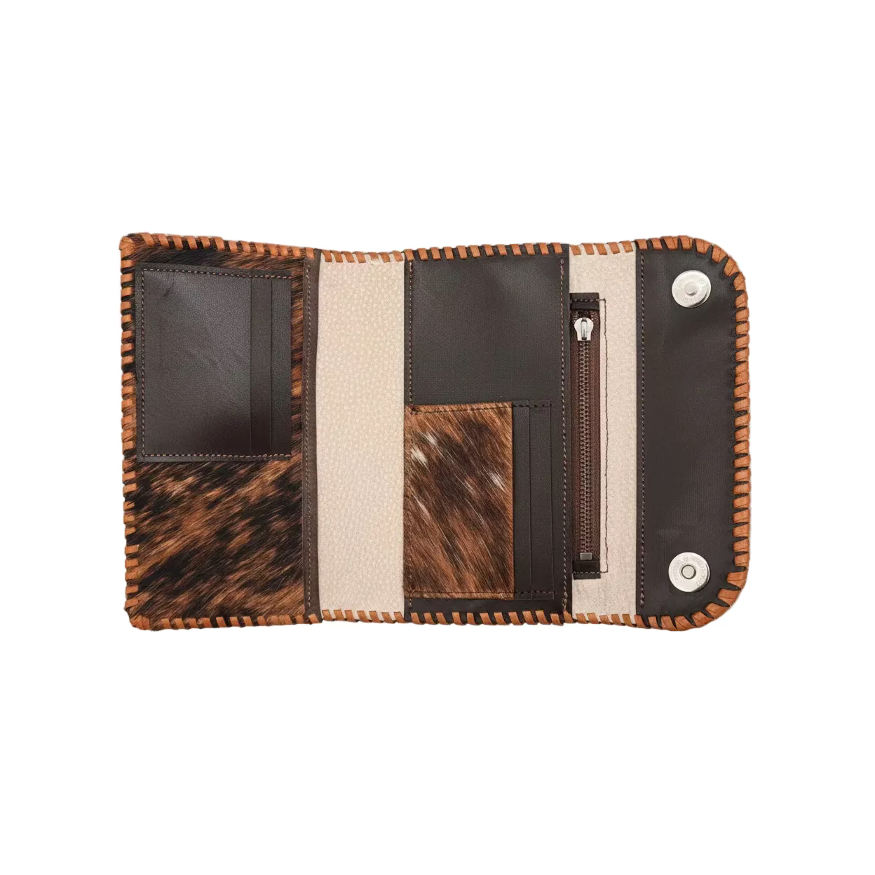 An open handmade leather wallet with mixed materials including dark brown leather, tan leather, and a brown and black hair-on-hide panel. A hand is holding the bottom left corner, and the wallet is photographed on a rustic wooden surface.