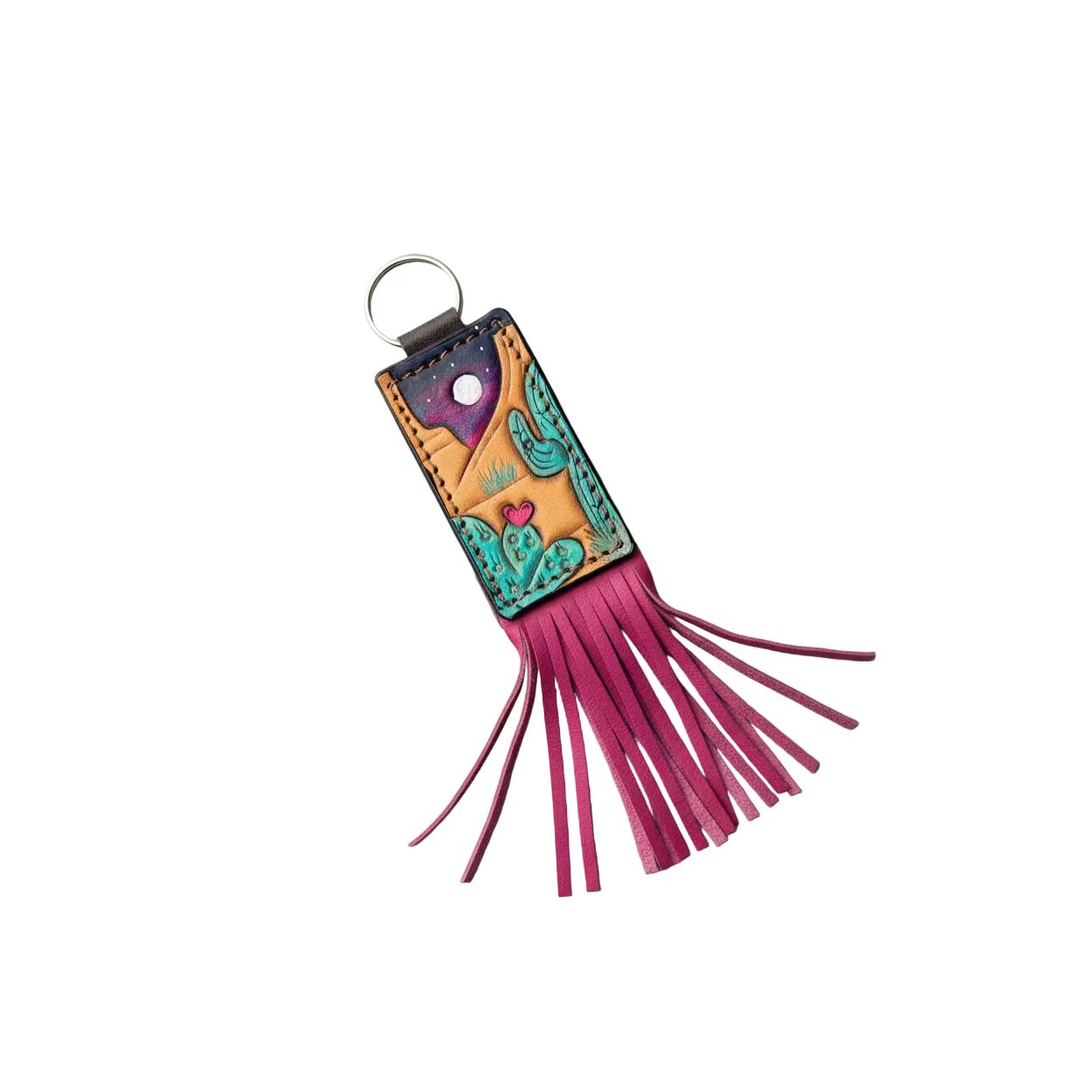 A hand-tooled leather keychain wallet featuring a desert landscape design with turquoise cacti, a pink heart, and a purple starry sky, finished with a bright pink leather fringe and a silver key ring, displayed on a rustic wooden background.