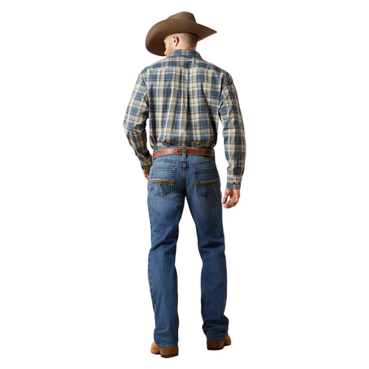 Man wearing a plaid shirt, jeans, and cowboy hat on a plain background