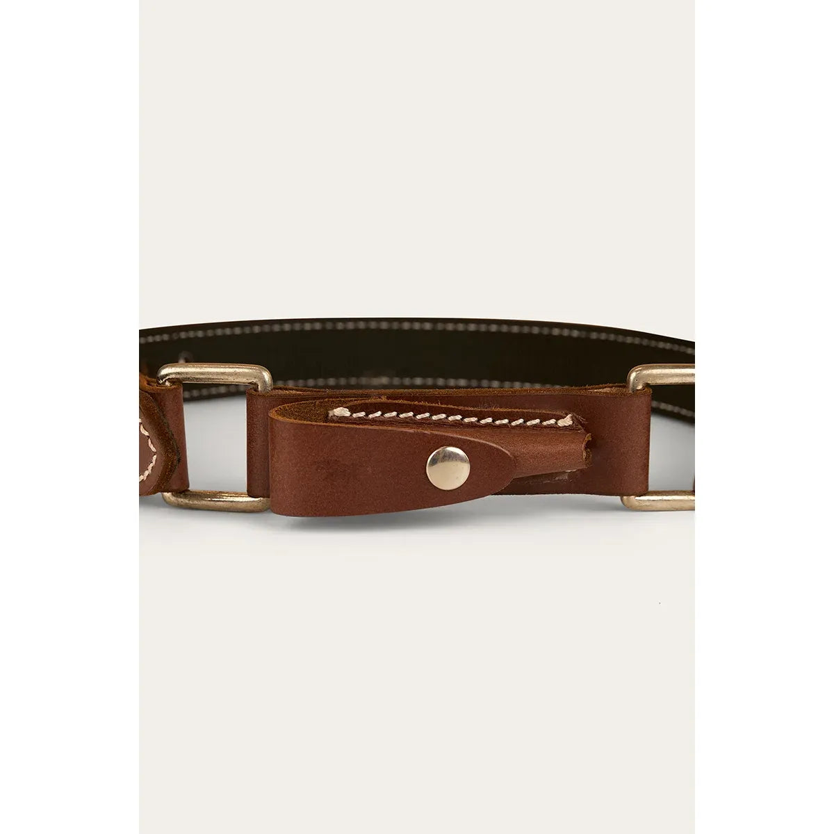 Brown leather belt with gold buckle on a light gray background