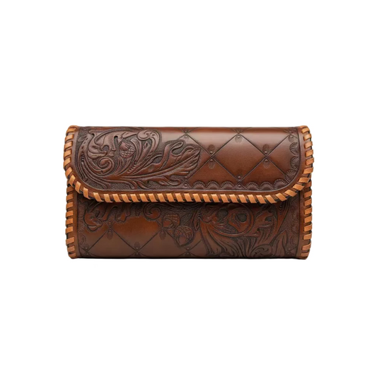 A brown tooled leather clutch bag with floral embossing, diamond-quilted stitching, and braided trim, shown on a neutral gray background.