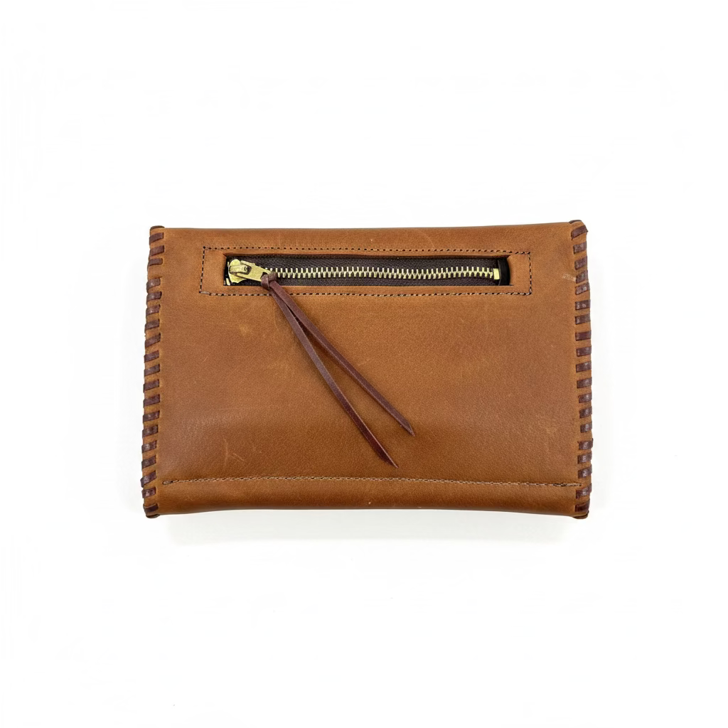 A brown leather wallet with a top zipper and leather zipper pull, shown on a plain white background.