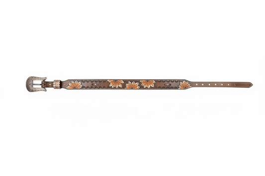 A western-style leather belt with a silver buckle, laid flat on a dark gray surface. The belt is brown with hand-tooled floral detailing in orange, white, and yellow, and features silver concho studs.