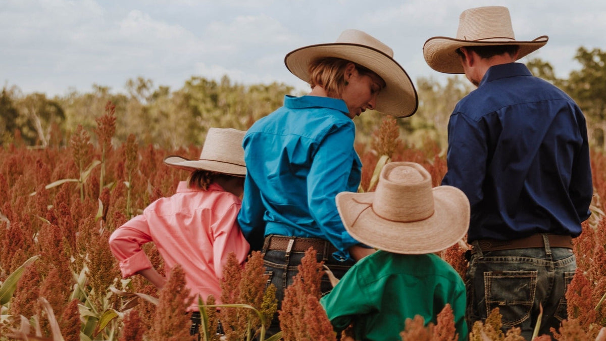 Family wearing western country clothing and hats in an Australian paddock for Billy Goats Country Outfitters